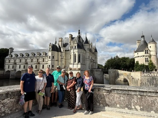 A group of people with a castle in the back
